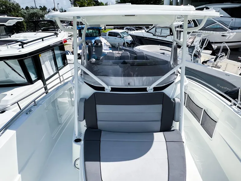 Slide: The Image of 2024 Jeanneau LEADER 9.0CC boat with sleek seating and modern design in a marina setting. - 15