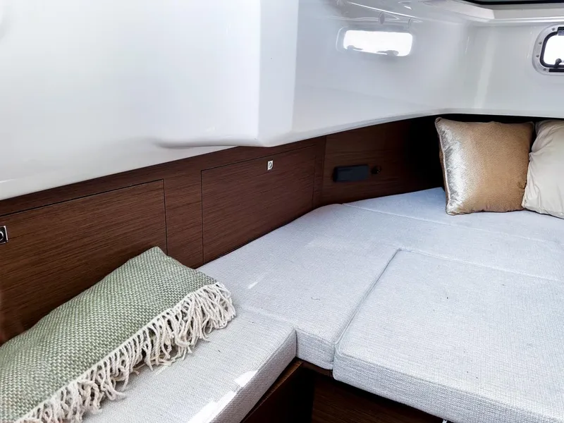 Slide: The Image of 2024 Jeanneau LEADER 9.0CC cabin interior with cozy bedding and cushions. - 21