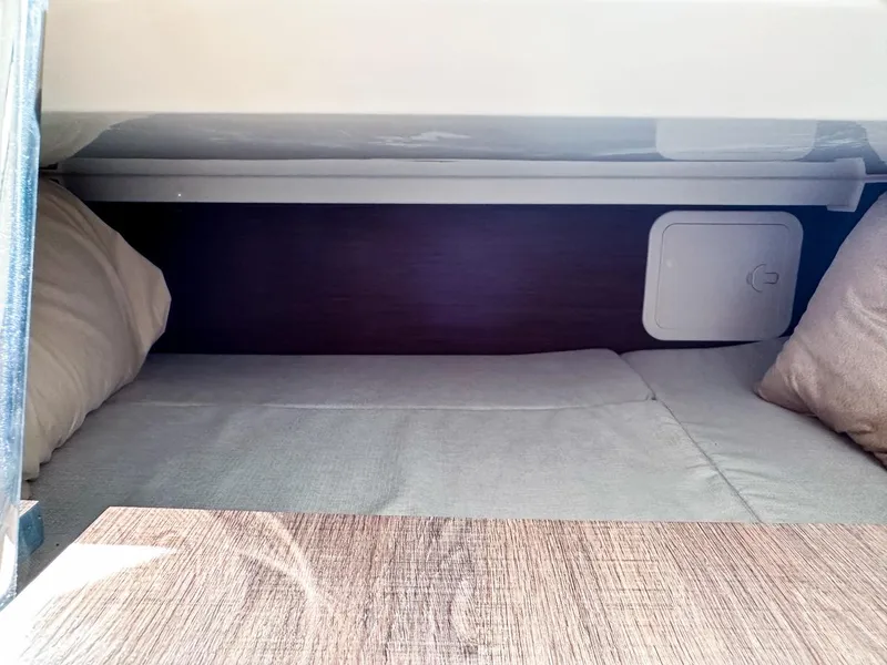 Slide: The Image of 2024 Jeanneau LEADER 9.0CC cabin interior with cozy bedding and wooden accents. - 23