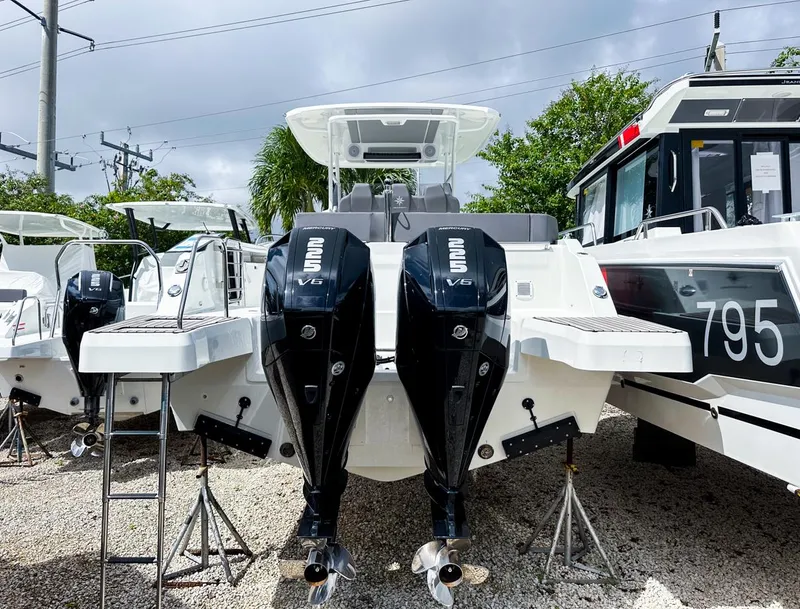 Slide: The Image of 2024 Jeanneau LEADER 9.0CC boat with dual outboard engines on display. - 5