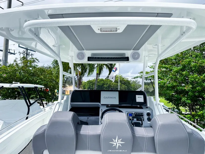 Slide: The Image of 2024 Jeanneau LEADER 9.0CC boat cockpit with Garmin navigation system and sleek seating. - 9