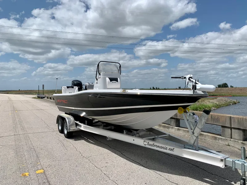 Slide: The Image of 2015 Epic 22SC Bay Boat on trailer under a partly cloudy sky. - 11