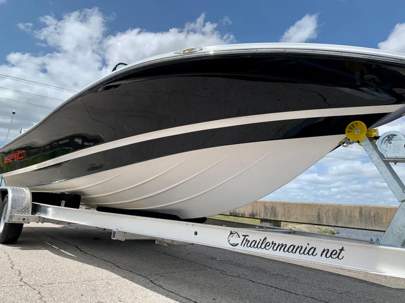 Slide: The Image of 2015 Epic 22SC Bay Boat on a trailer, black and white hull, clear sky background. - 13