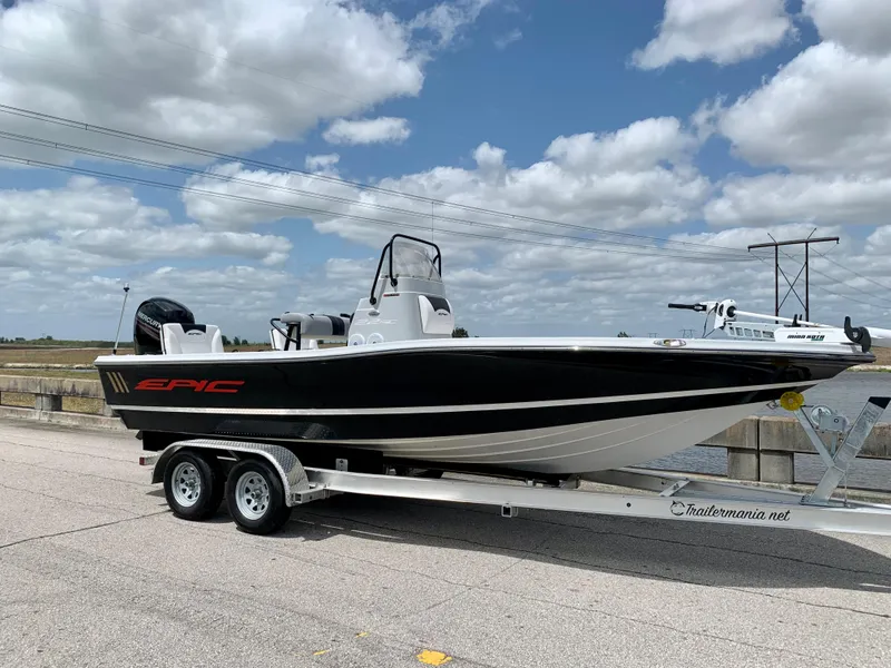 Slide: The Image of 2015 Epic 22SC Bay Boat on a trailer under a partly cloudy sky. - 8
