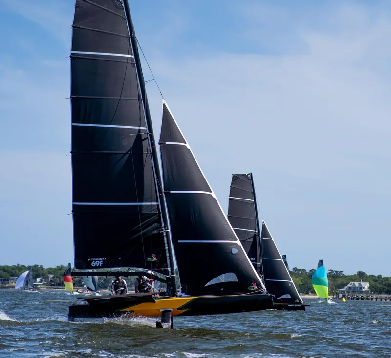 Slide: The Image of Sailboats racing on water, featuring 2022 Persico 69F model with black sails. - 3