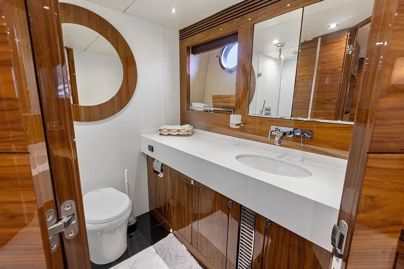 Slide: The Image of Luxurious bathroom in 2015 Sunseeker Predator 68 yacht with modern fixtures and wooden accents. - 29