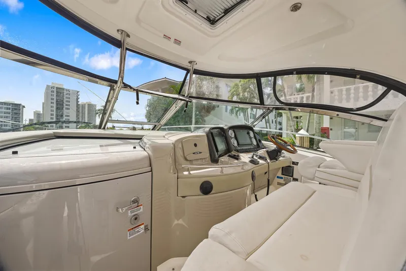 Slide: The Image of 2008 Sea Ray 44 Sundancer helm with modern controls and cityscape view. - 13