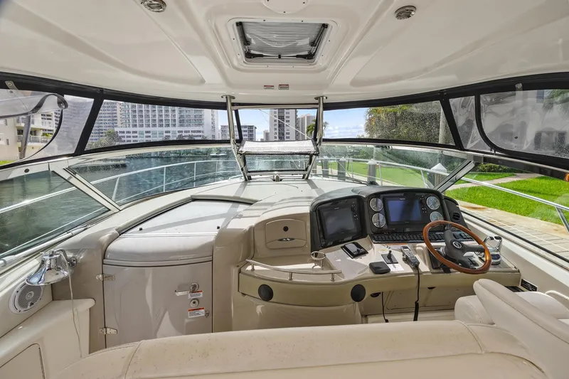 Slide: The Image of 2008 Sea Ray 44 Sundancer yacht cockpit with modern navigation equipment and luxurious seating. - 14