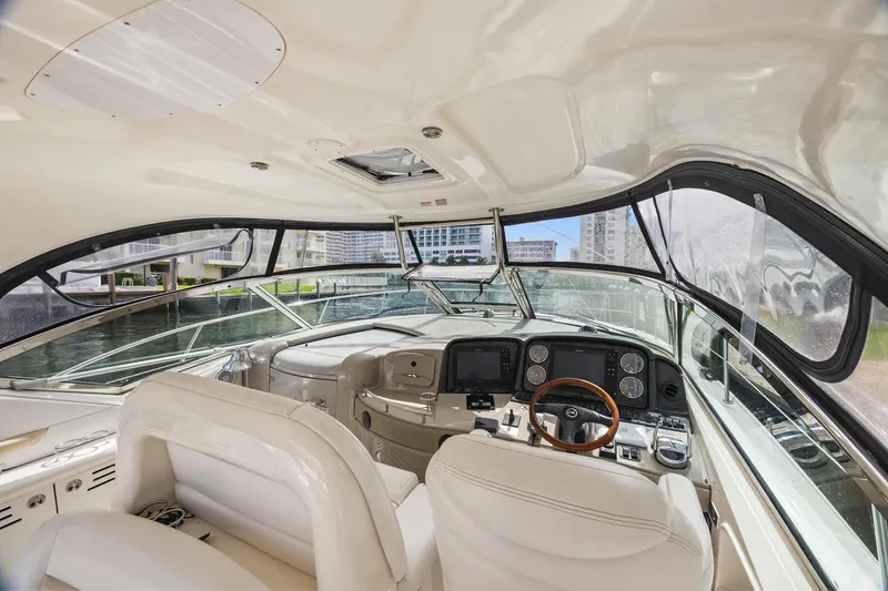 Slide: The Image of Interior view of 2008 Sea Ray 44 Sundancer yacht cockpit with modern controls and seating. - 16