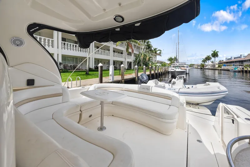 Slide: The Image of 2008 Sea Ray 44 Sundancer yacht with spacious seating, docked by a canal. - 17