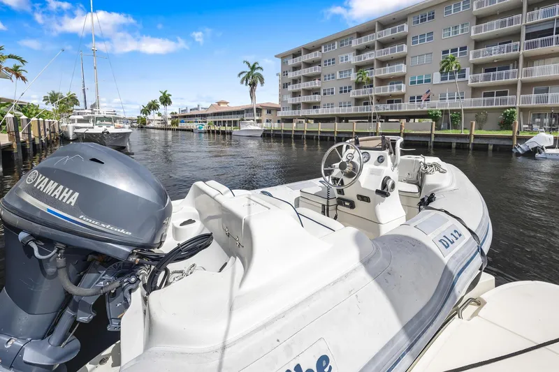 Slide: The Image of 2008 Sea Ray 44 Sundancer docked near waterfront apartments, featuring Yamaha engine. - 22