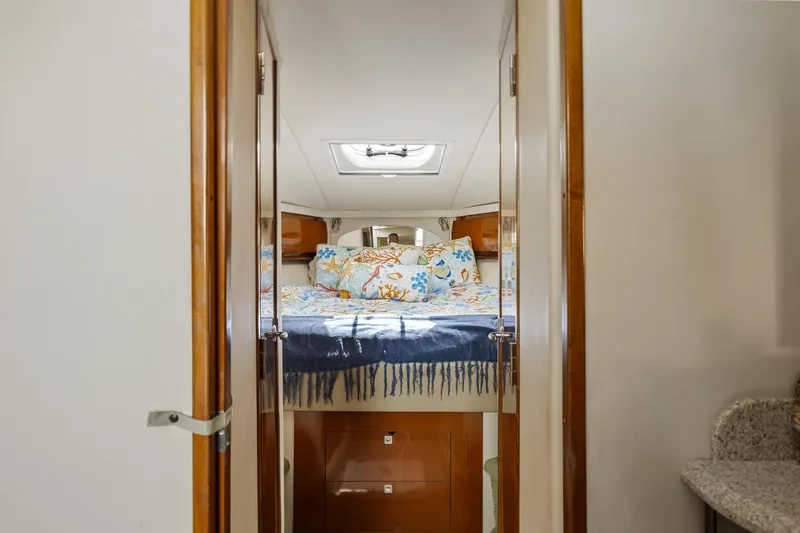 Slide: The Image of 2008 Sea Ray 44 Sundancer cabin interior with cozy bed and skylight. - 25