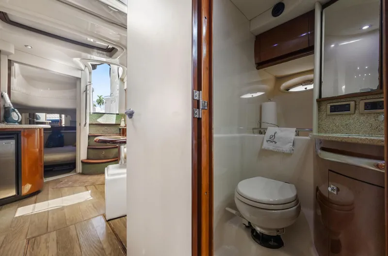 Slide: The Image of 2008 Sea Ray 44 Sundancer interior with bathroom and living area, showcasing luxury yacht design. - 26