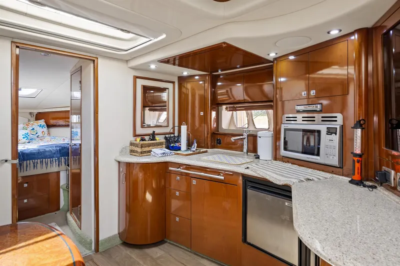 Slide: The Image of Luxurious 2008 Sea Ray 44 Sundancer yacht interior with modern kitchen and cozy bedroom. - 29