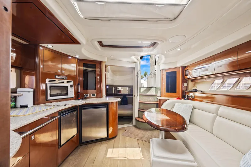 Slide: The Image of Luxurious interior of 2008 Sea Ray 44 Sundancer yacht with modern kitchen and seating area. - 32
