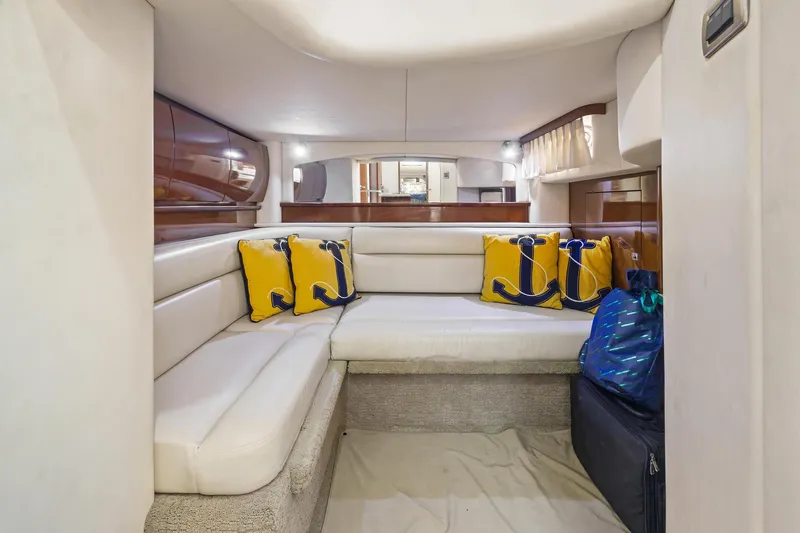 Slide: The Image of Interior of 2008 Sea Ray 44 Sundancer with cozy seating and nautical-themed cushions. - 39