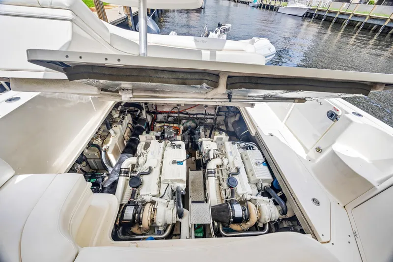 Slide: The Image of Engine compartment of 2008 Sea Ray 44 Sundancer yacht, showcasing dual engines by the water. - 42