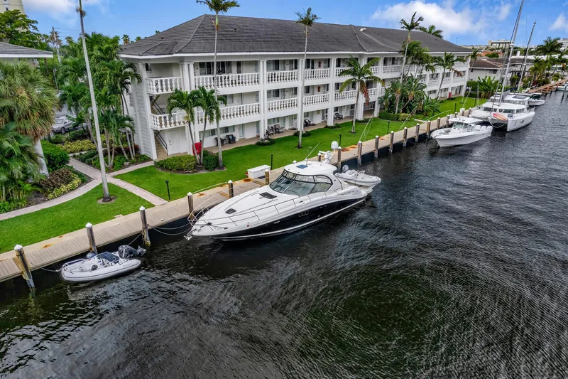 Slide: The Image of 2008 Sea Ray 44 Sundancer yacht docked by waterfront apartments. - 46