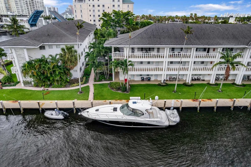 Slide: The Image of 2008 Sea Ray 44 Sundancer yacht docked near waterfront buildings. - 49