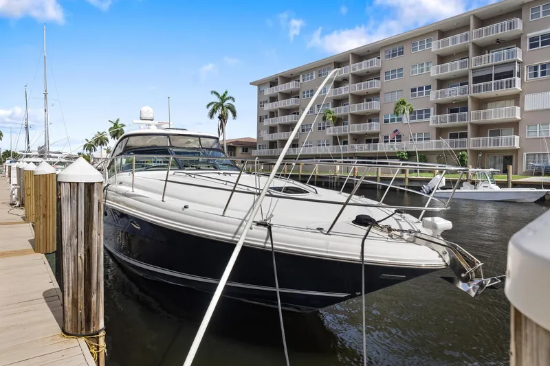 Slide: The Image of 2008 Sea Ray 44 Sundancer yacht docked near waterfront apartments. - 6