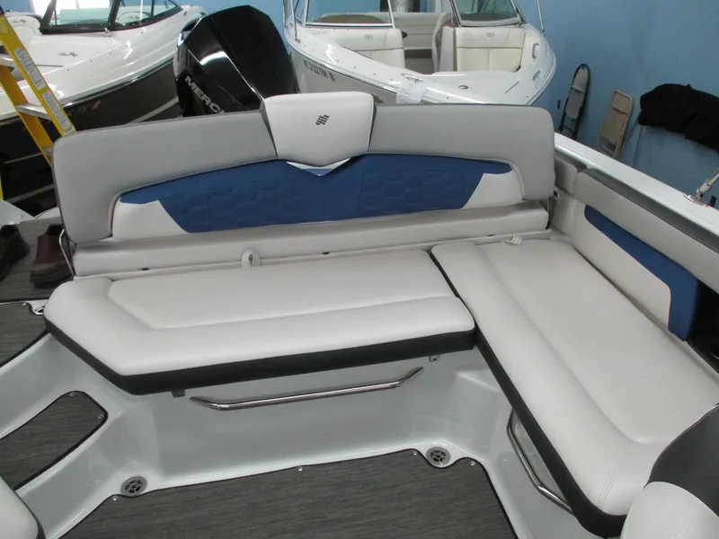 Slide: The Image of Interior of a 2021 Four Winns HD3 RS boat with white and blue seating. - 12