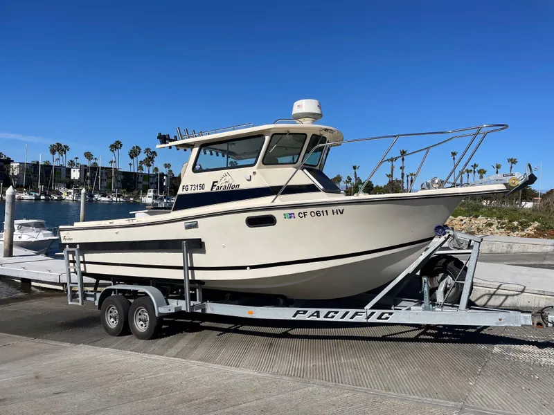 Slide: The Image of 1984 Farallon 25 Whaleback boat on a Pacific trailer at a marina. - 5
