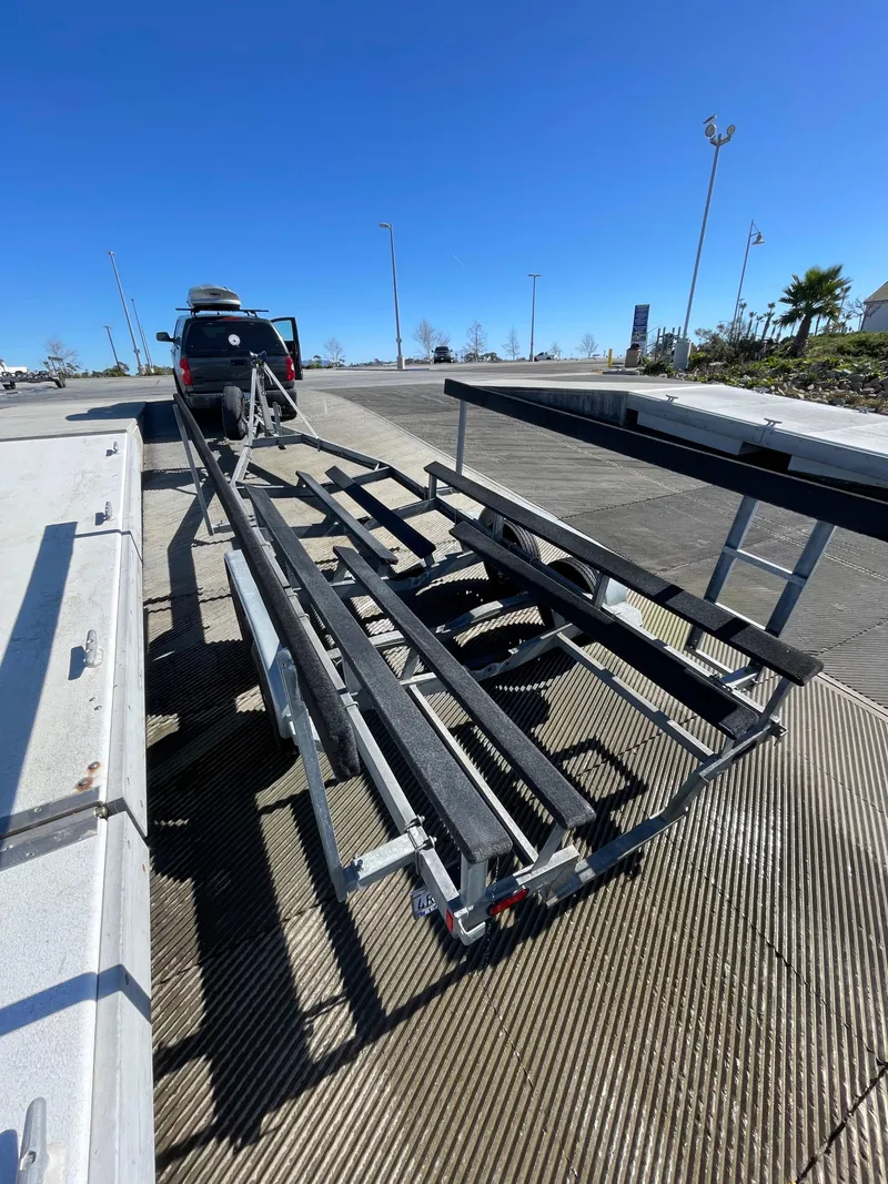 Slide: The Image of Boat trailer for 1984 Farallon 25 Whaleback at a dock under clear blue sky. - 7