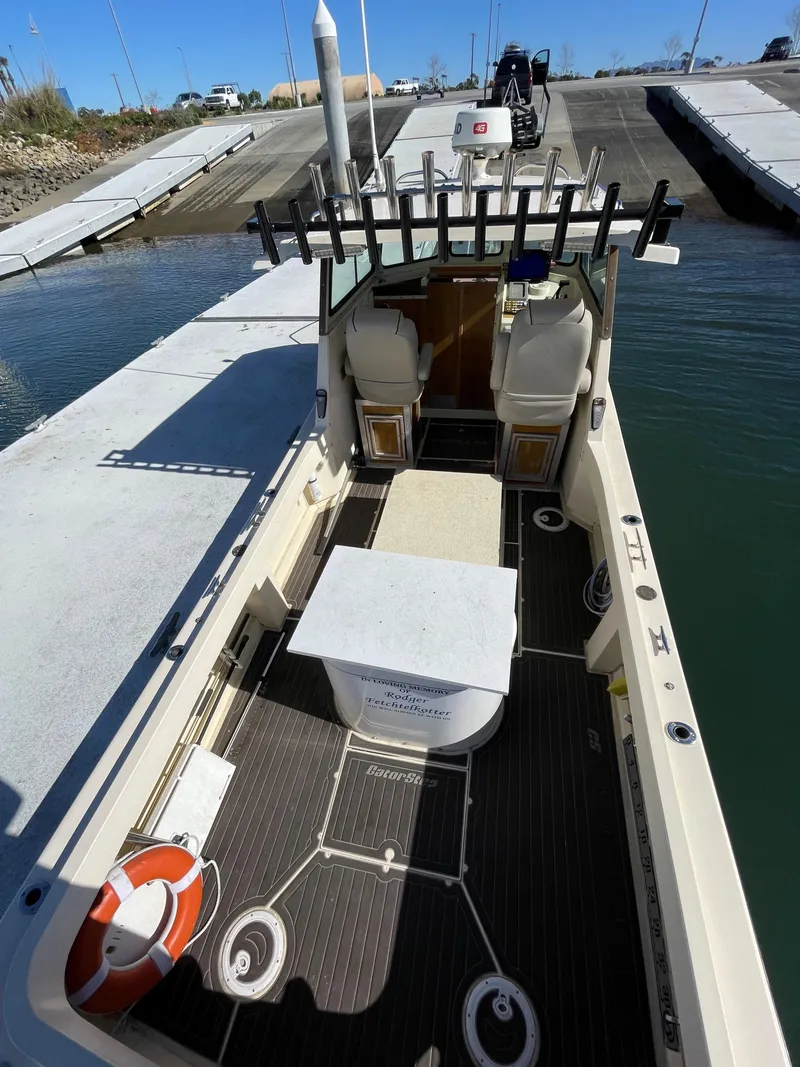 Slide: The Image of 1984 Farallon 25 Whaleback boat docked at a marina, view of the deck and seating area. - 9