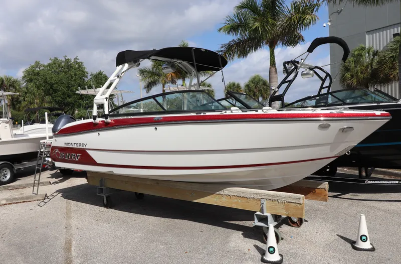 The Image of 2018 Monterey 238SS boat on display with palm trees in the background. - 0