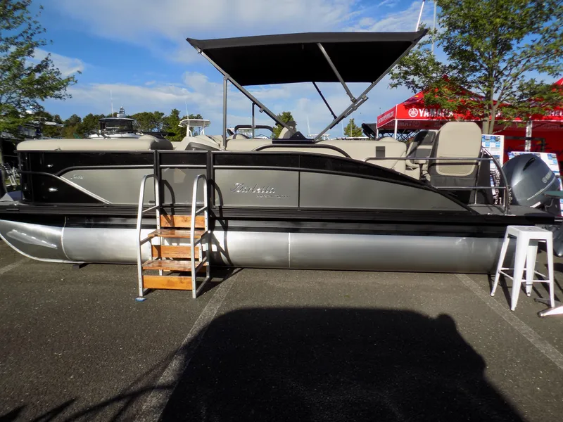 Slide: The Image of 2023 Barletta C22CC pontoon boat with canopy, displayed outdoors on pavement. - 3