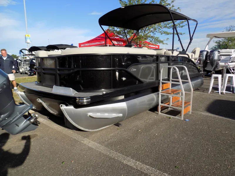 Slide: The Image of 2023 Barletta C22CC pontoon boat with canopy, displayed outdoors on a sunny day. - 4