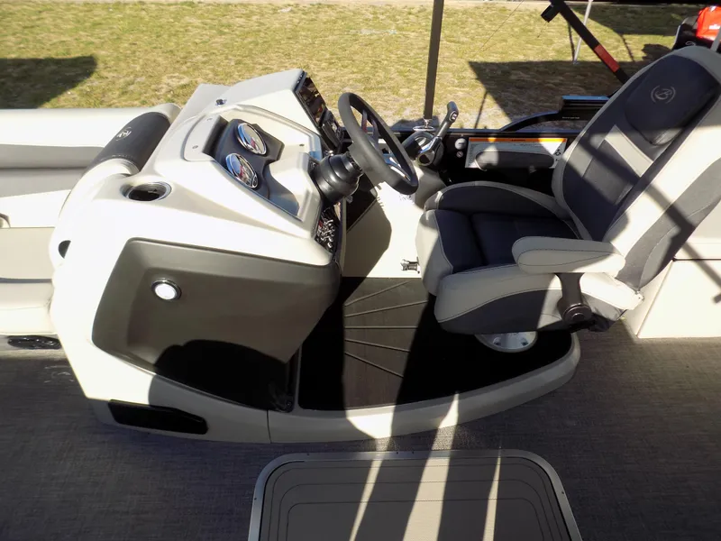 Slide: The Image of 2023 Barletta C22CC boat cockpit with steering wheel and comfortable seating. - 7