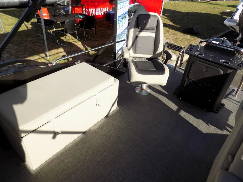 Slide: The Image of 2023 Barletta C22CC boat interior with seating and storage, displayed outdoors. - 8