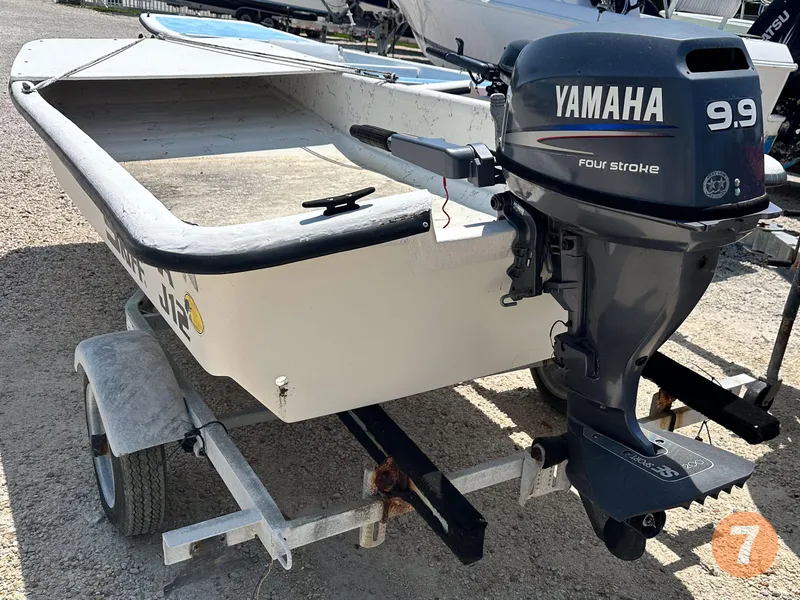 Slide: The Image of 1998 Carolina Skiff J12 with Yamaha 9.9 four-stroke engine on trailer. - 10