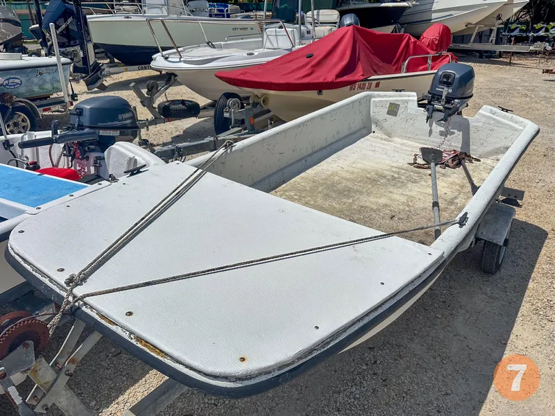 Slide: The Image of 1998 Carolina Skiff J12 Skiff boat on trailer with outboard motor. - 12