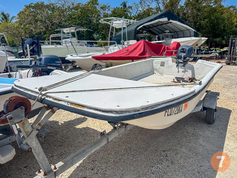 Slide: The Image of 1998 Carolina Skiff J12 Skiff on trailer in boatyard. - 13