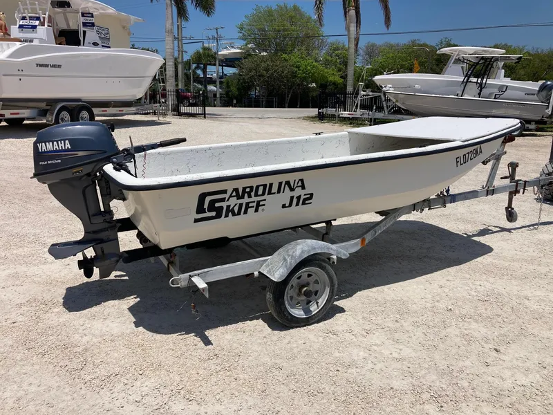Slide: The Image of 1998 Carolina Skiff J12 boat on trailer with Yamaha outboard motor. - 4