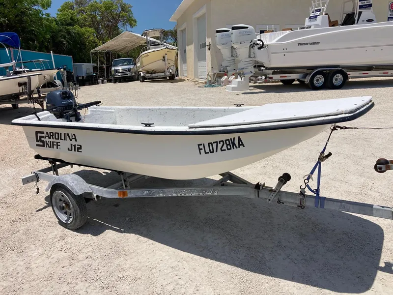 Slide: The Image of 1998 Carolina Skiff J12 boat on trailer in outdoor storage area. - 5