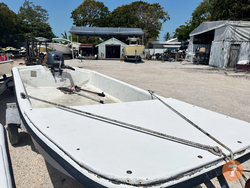 Slide: The Image of 1998 Carolina Skiff J12 Skiff boat in a boatyard. - 9