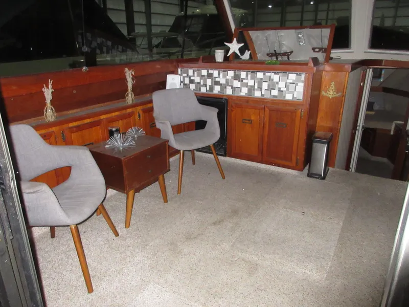 Slide: The Image of Interior of a 1978 Pacemaker 40 Sport Fish boat with modern seating and wooden cabinetry. - 10