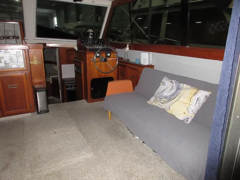 Slide: The Image of Interior of a 1978 Pacemaker 40 Sport Fish boat with sofa and helm station. - 11
