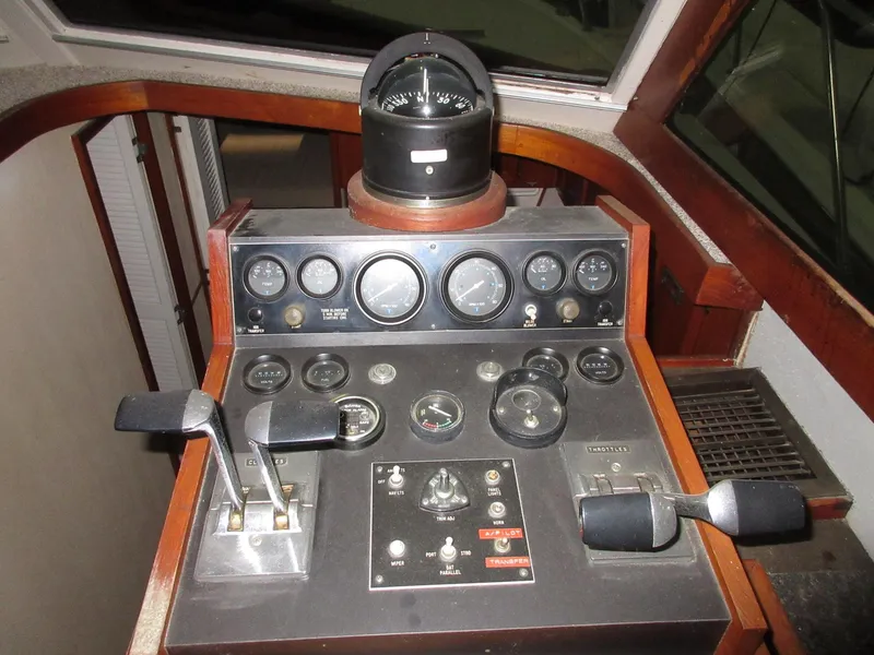 Slide: The Image of 1978 Pacemaker 40 Sport Fish boat control panel with gauges and compass. - 14