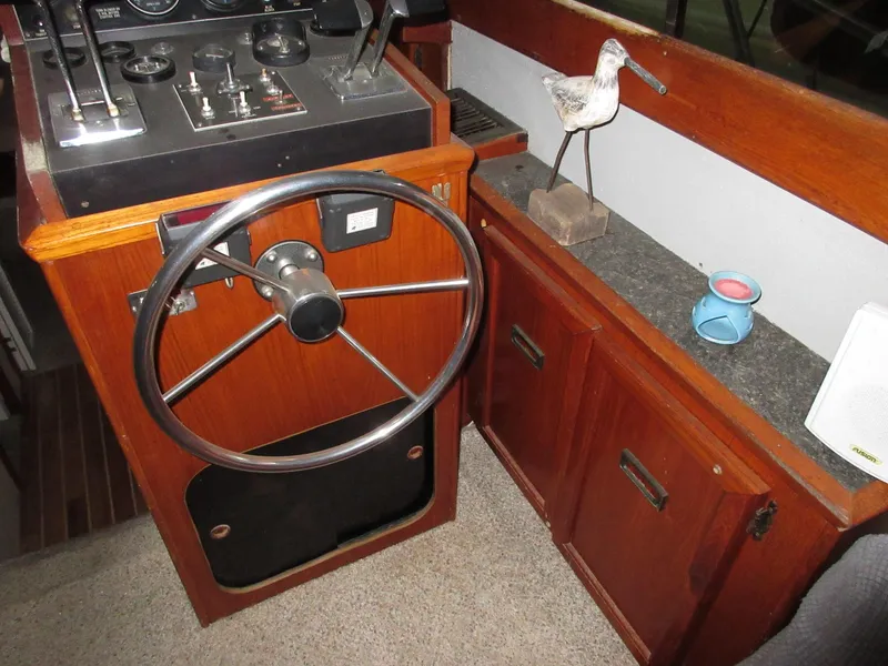 Slide: The Image of 1978 Pacemaker 40 Sport Fish helm with wooden cabinetry and nautical decor. - 15