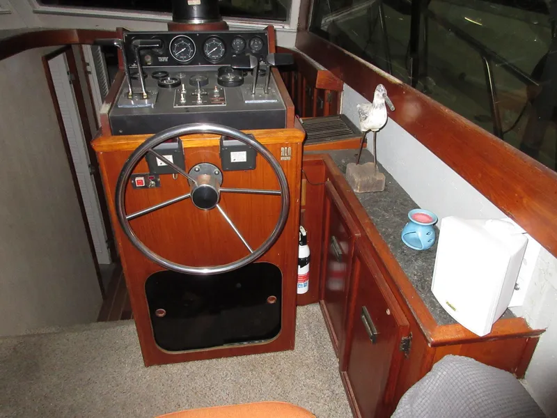 Slide: The Image of 1978 Pacemaker 40 Sport Fish boat helm with wooden cabinetry and nautical decor. - 16