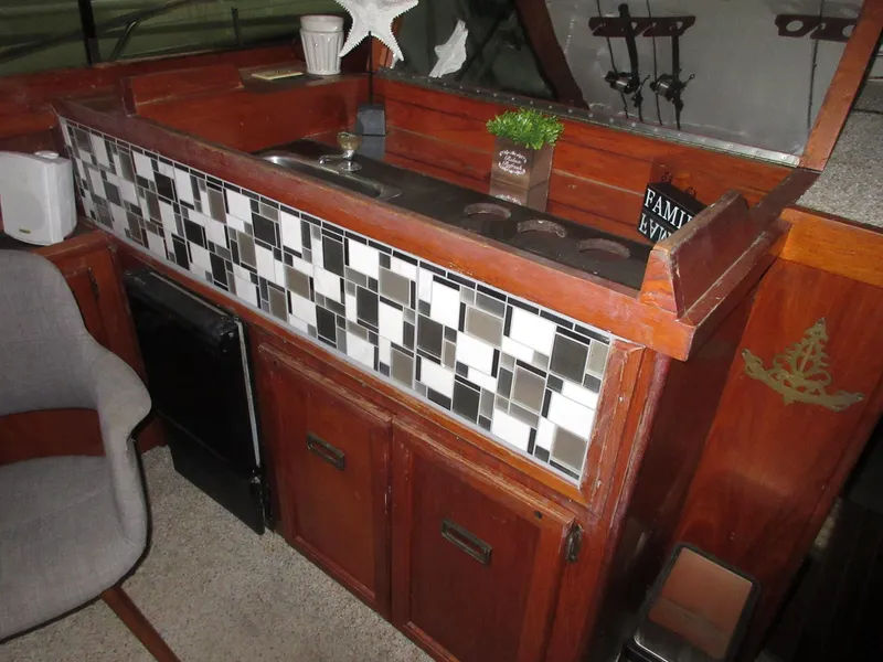 Slide: The Image of 1978 Pacemaker 40 Sport Fish boat interior with wooden cabinetry and tiled backsplash. - 18