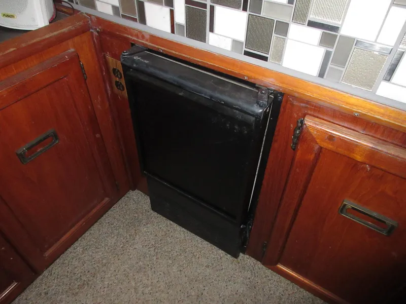 Slide: The Image of 1978 Pacemaker 40 Sport Fish kitchen with wooden cabinets and black appliance. - 19