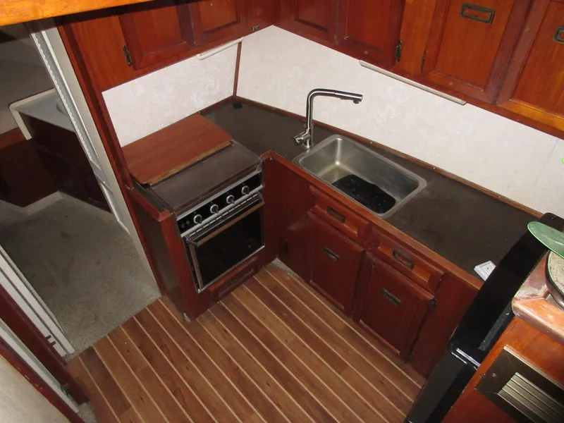 Slide: The Image of 1978 Pacemaker 40 Sport Fish galley with stove, sink, and wooden cabinetry. - 20