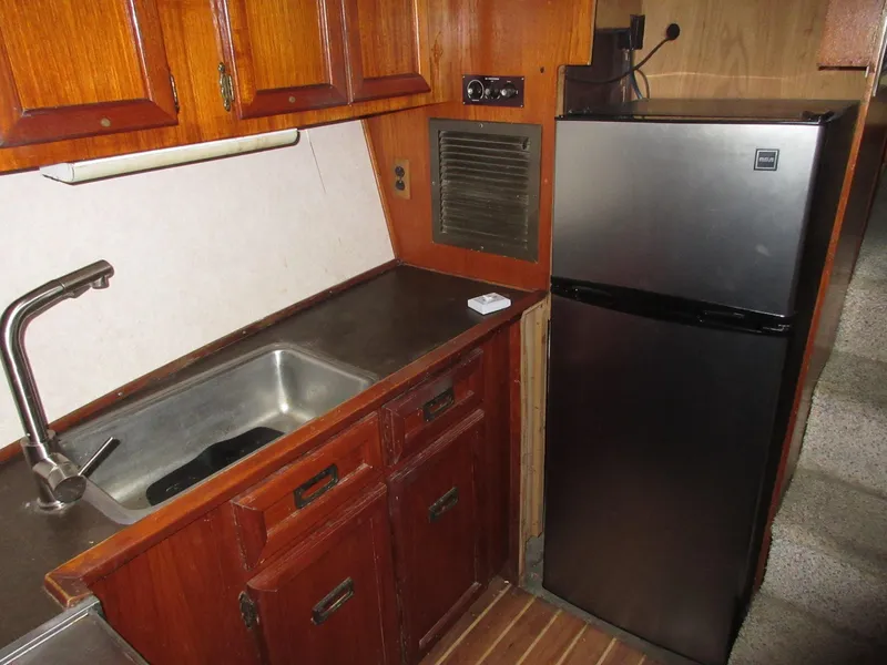 Slide: The Image of 1978 Pacemaker 40 Sport Fish kitchen with stainless steel sink and refrigerator. - 21