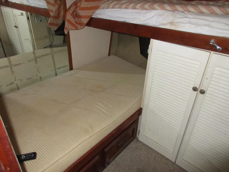 Slide: The Image of 1978 Pacemaker 40 Sport Fish cabin interior with bunk beds and storage. - 25