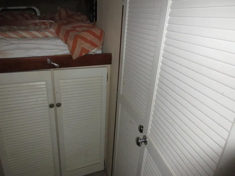 Slide: The Image of Interior cabin of 1978 Pacemaker 40 Sport Fish boat with bed and storage cabinets. - 27
